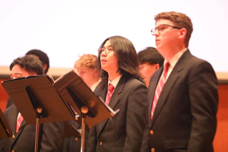 a group of people standing in front of a microphone