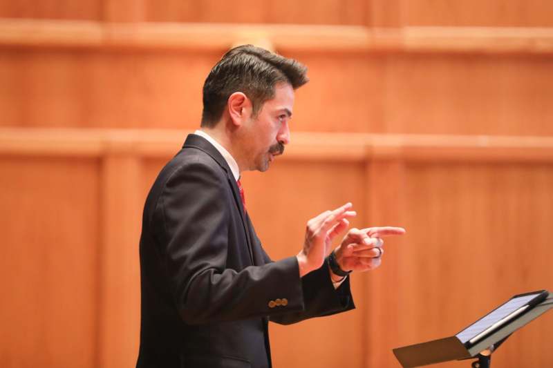 a man in a suit pointing at something