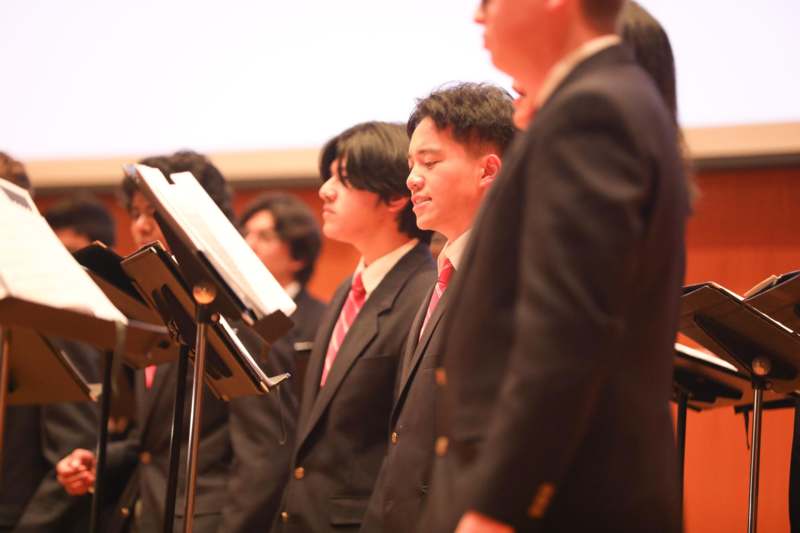 a group of people standing in front of a microphone