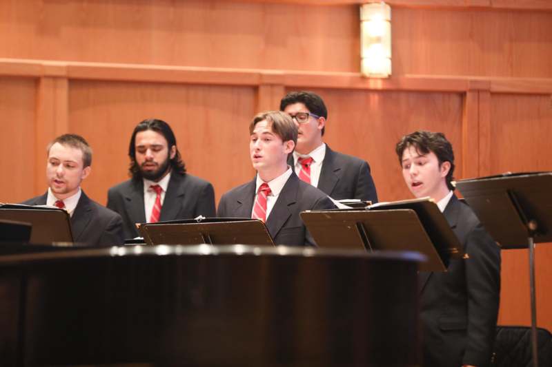 a group of men in suits singing