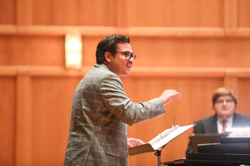 a man standing in front of a piano