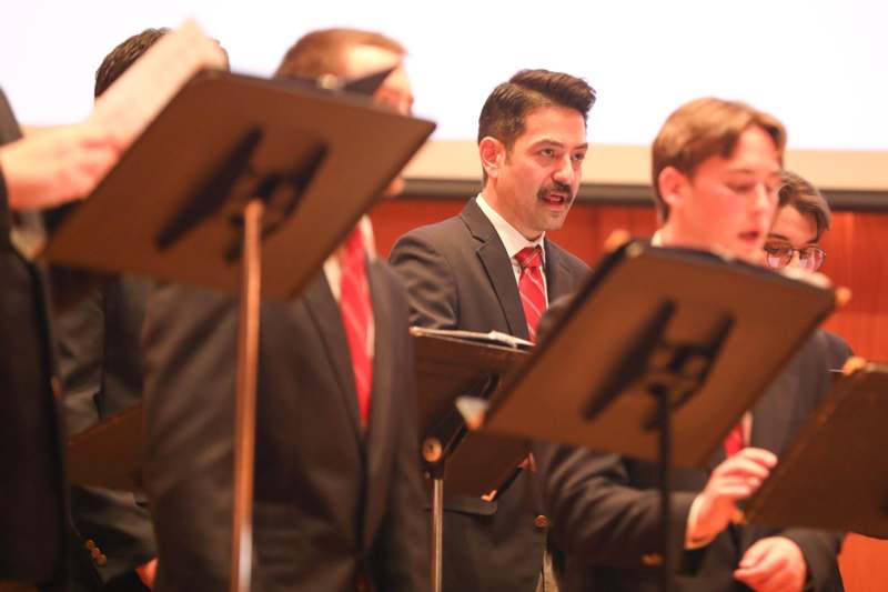 a group of men in suits playing music