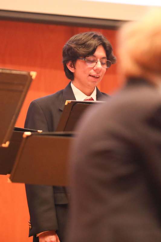 a man in a suit playing music