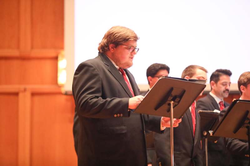 a man standing in front of a stand
