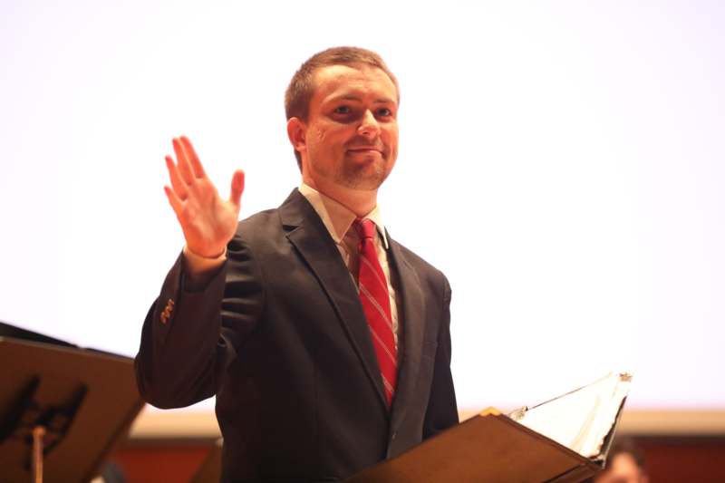 a man in a suit holding a book