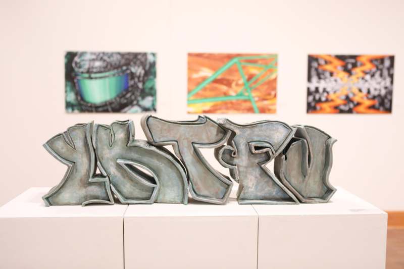 a group of metal letters on a white surface