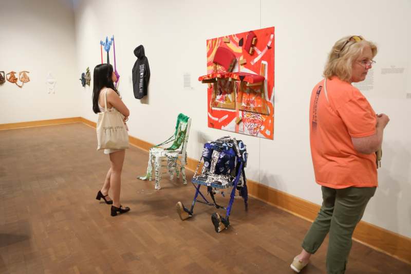 a group of people looking at art on the wall