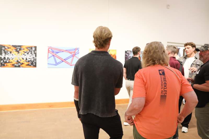 a group of people looking at art