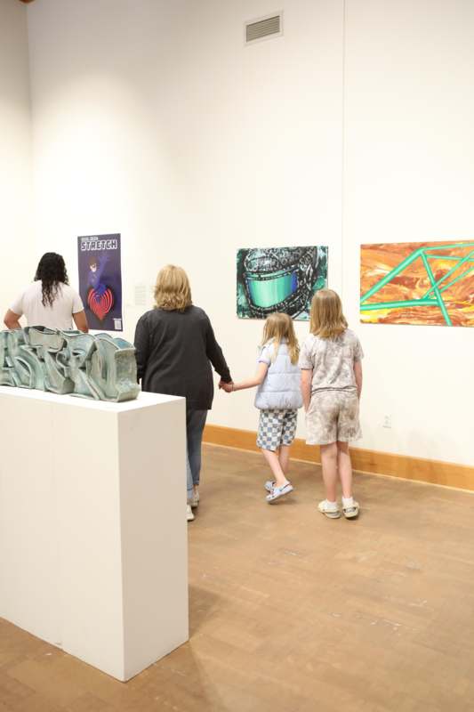 a group of people looking at art