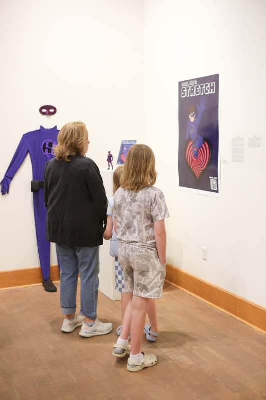 a group of people looking at a poster on a wall