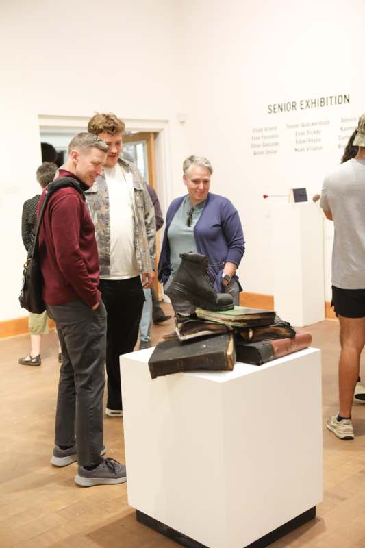 a group of people standing around a display of shoes