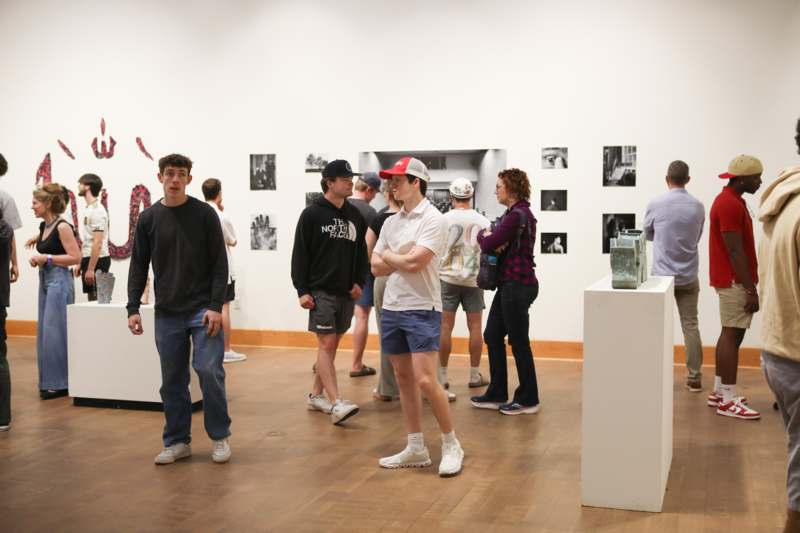 a group of people in a room with pictures on the wall