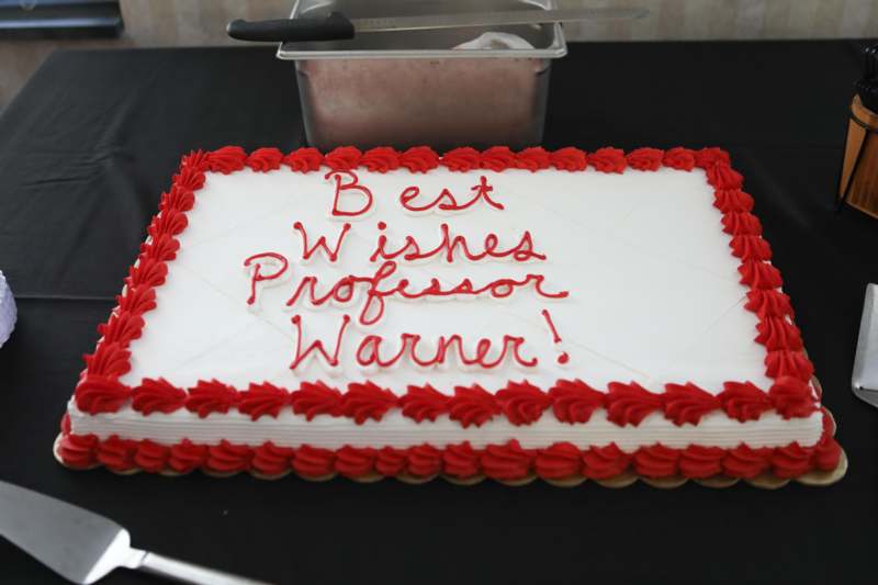 Rick Warner Retirement Reception - a cake with red frosting on it