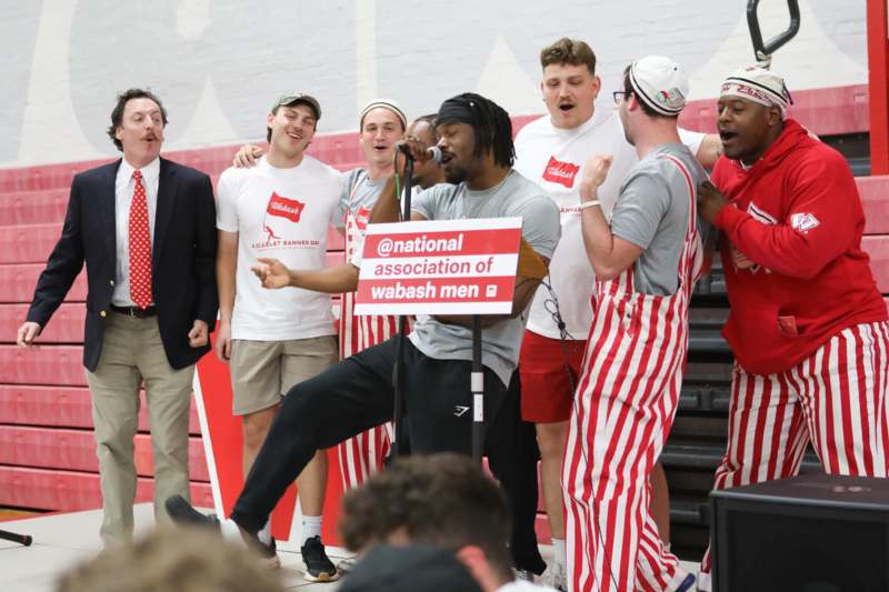 a group of men singing into a microphone