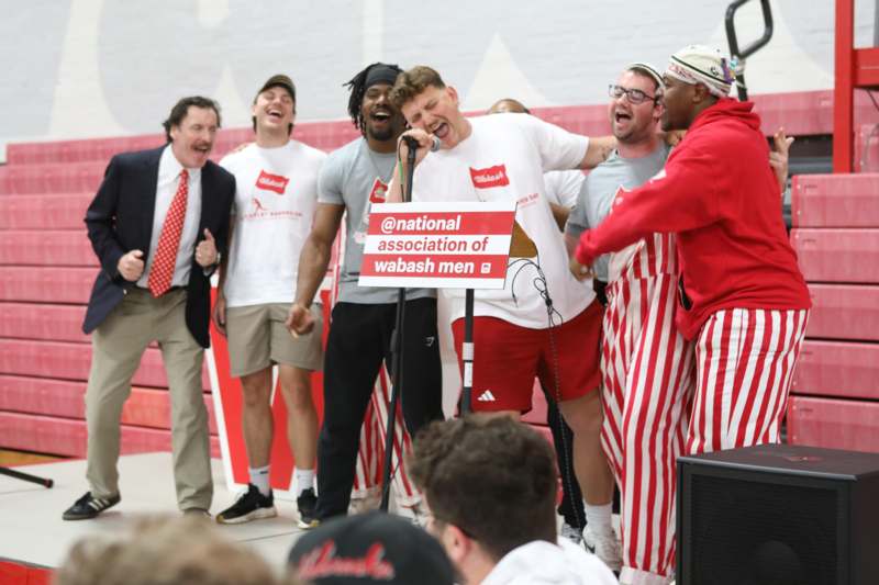 a group of men singing into a microphone