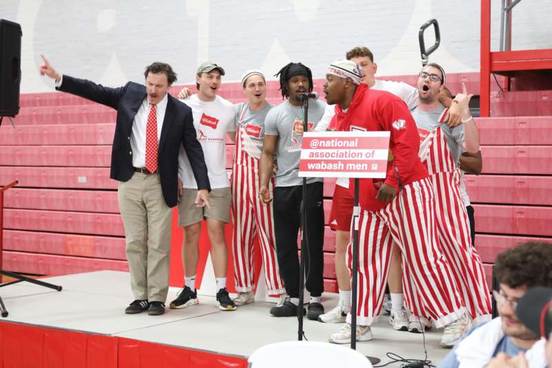 a group of men singing on a stage