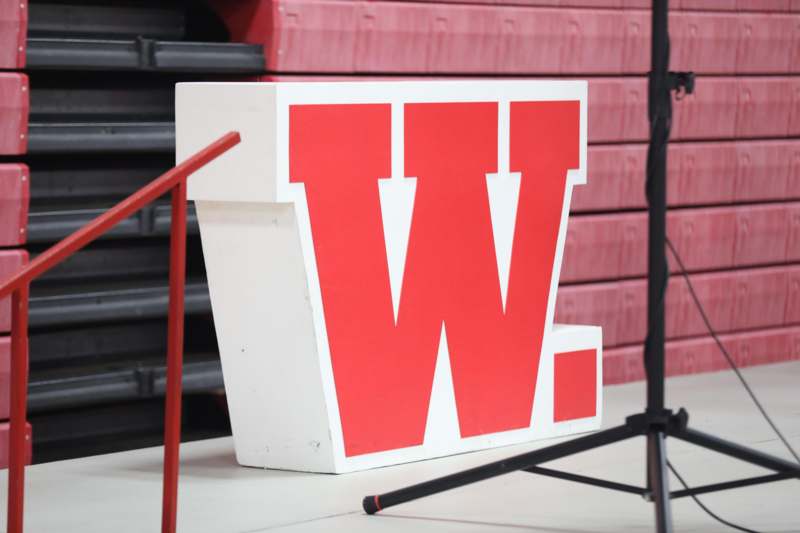 a white and red sign on a stage
