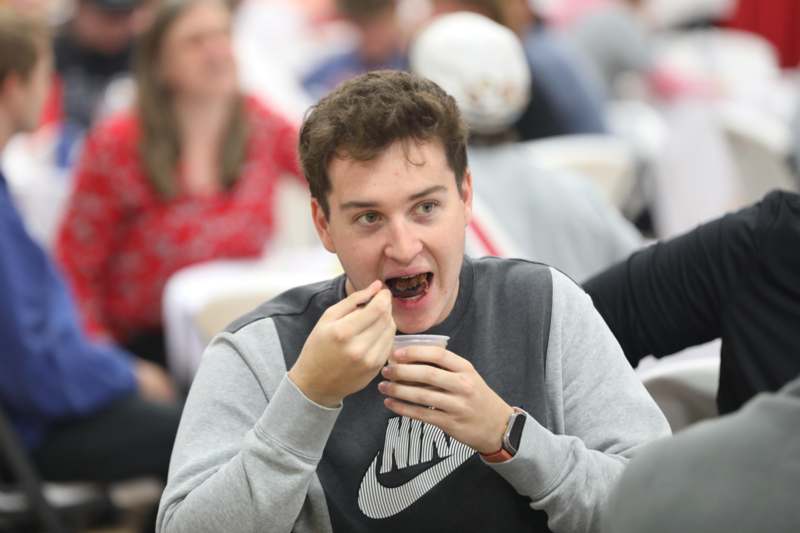 a man eating food with a spoon
