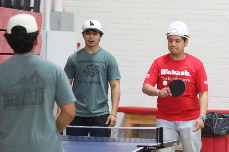 a group of men playing ping pong