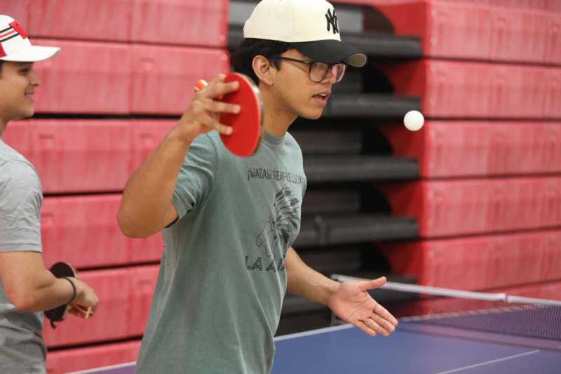 a man playing ping pong