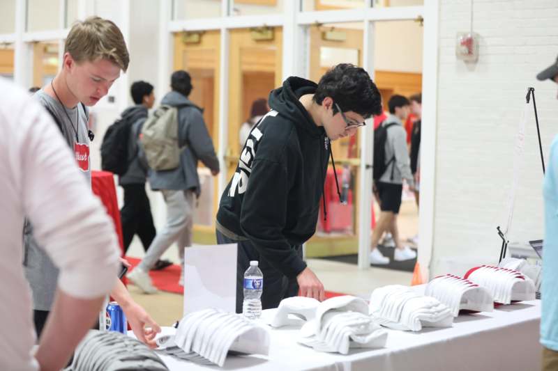 a group of people standing around a table