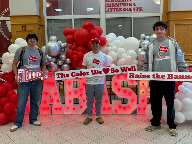 a group of people standing in front of balloons