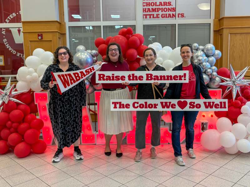 a group of women holding signs