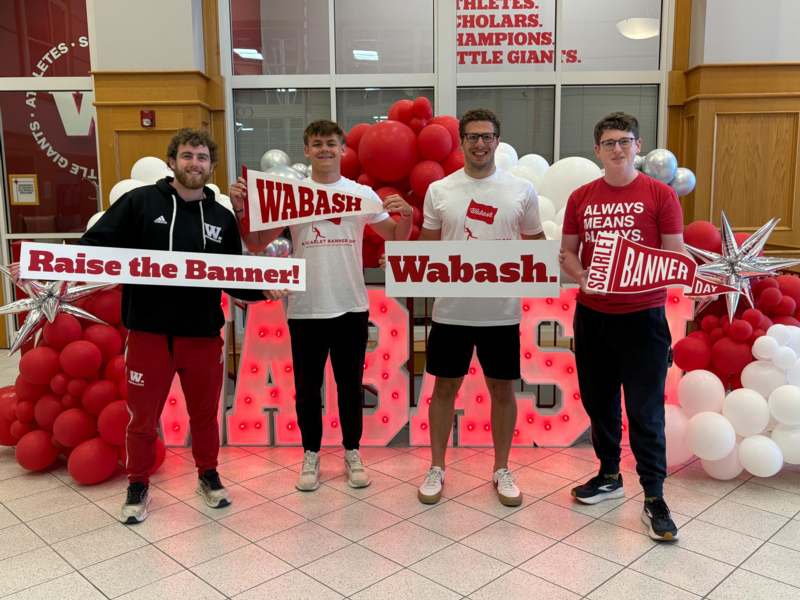 a group of men holding signs