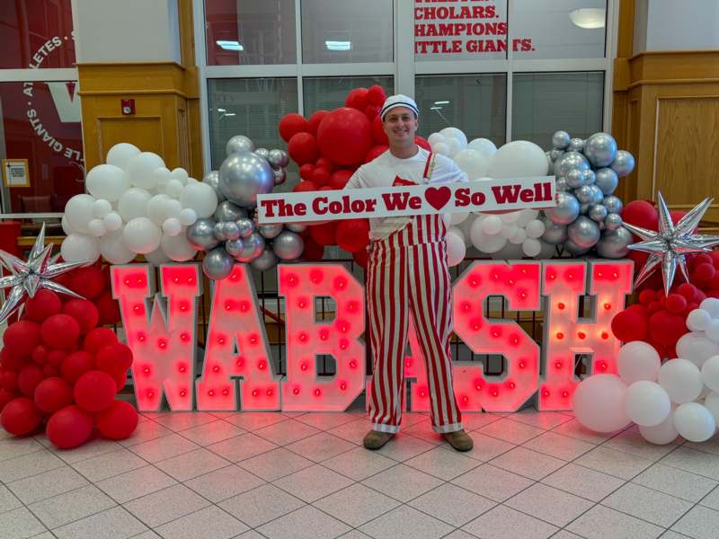 a man standing in front of a sign