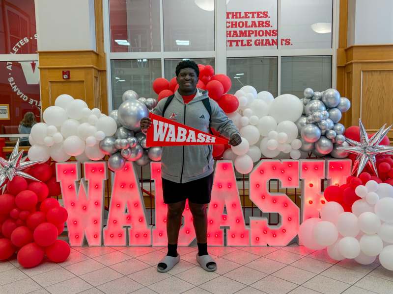 a man standing in front of a large sign