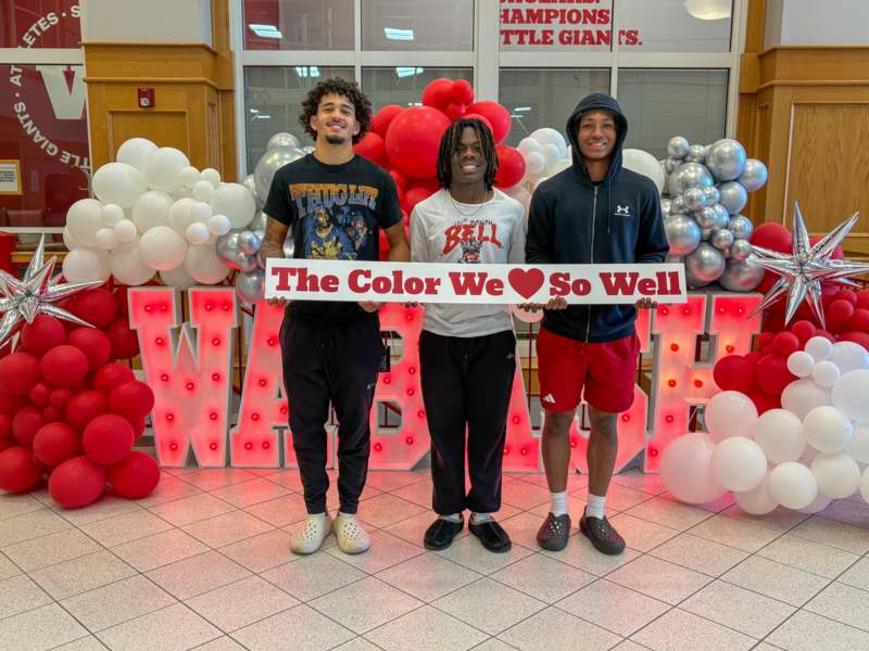 a group of men holding a sign