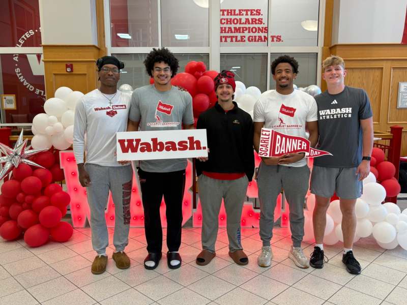 a group of men posing for a photo