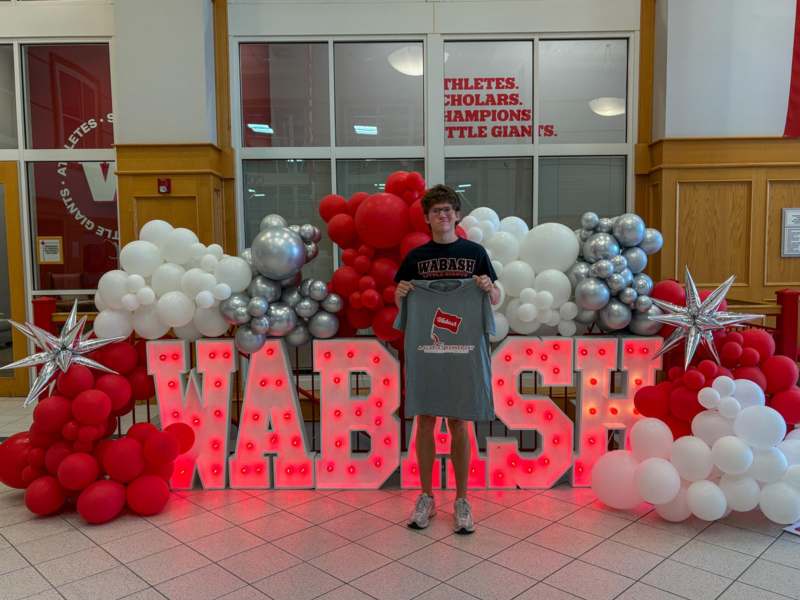 a person standing in front of balloons