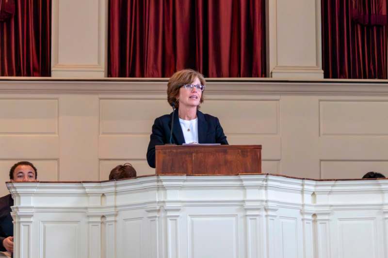 a woman standing at a podium