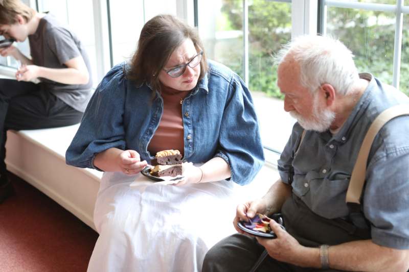 a woman looking at a piece of cake