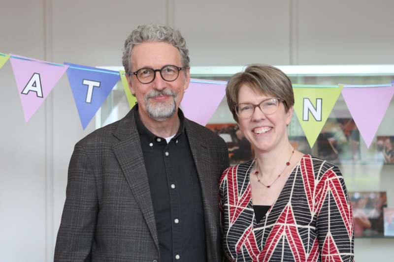 a man and woman standing together smiling
