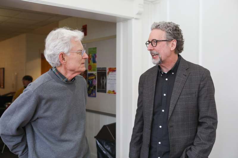 two men standing in a doorway