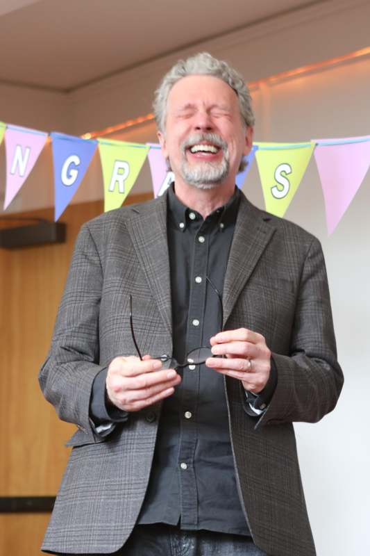 a man smiling with his eyes closed