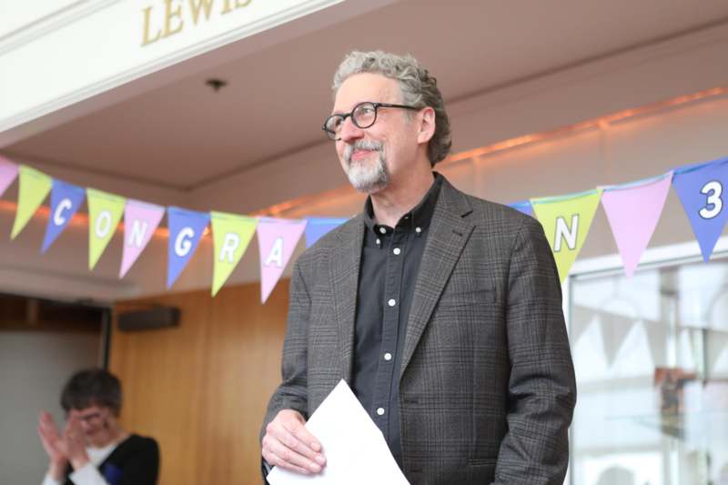 a man in a suit holding a piece of paper