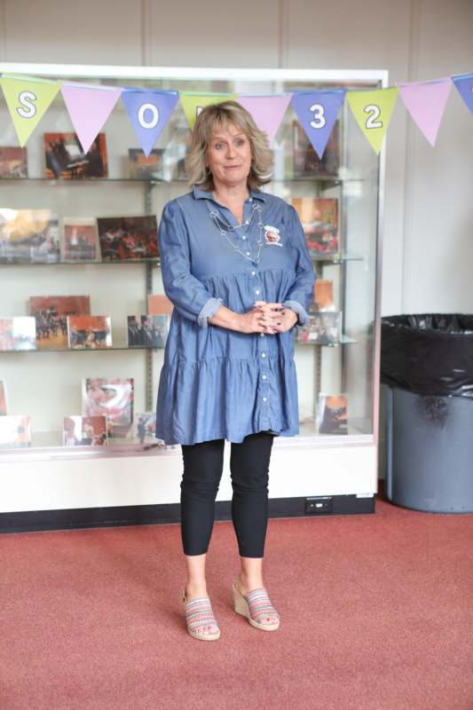 a woman standing in front of a display case