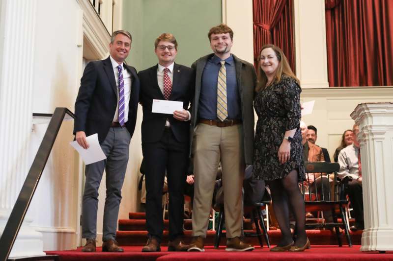 a group of people standing on a red carpet