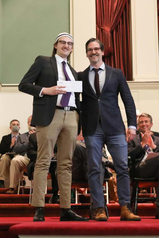 two men standing on a stage