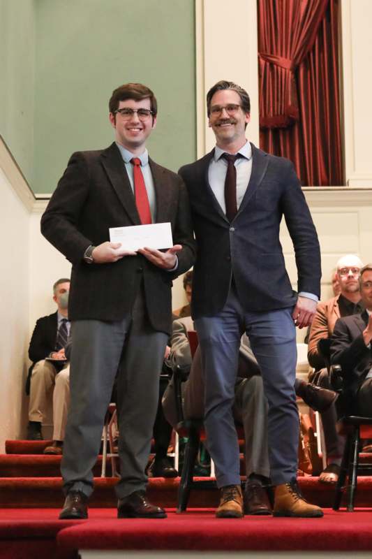 two men standing on stairs