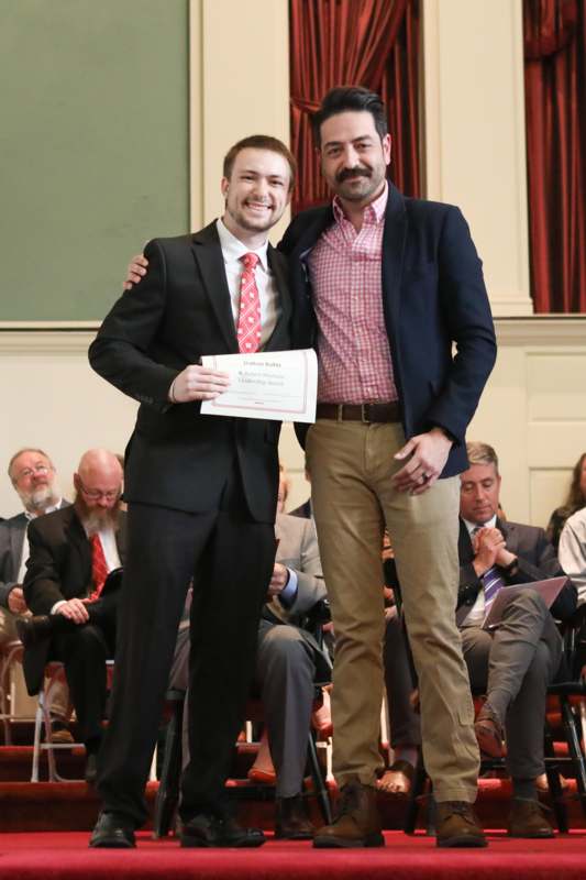 two men standing on a stage