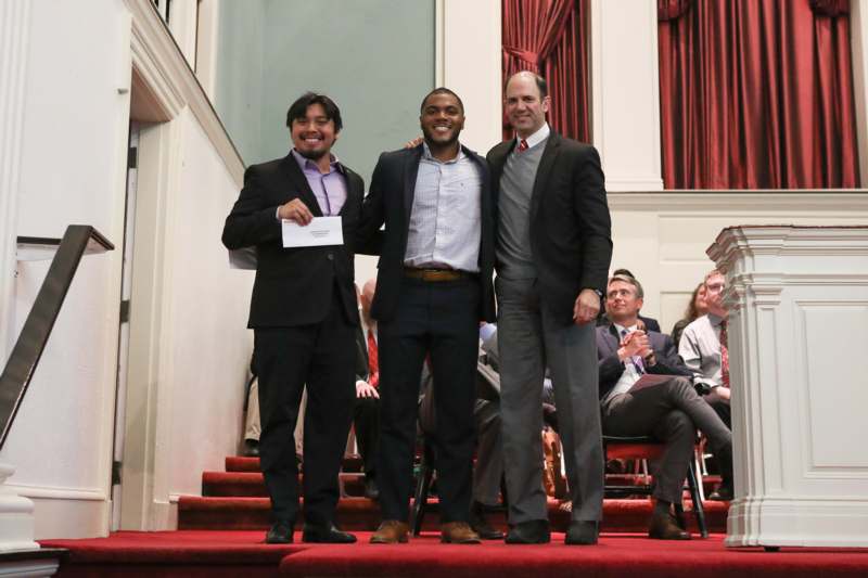 a group of men standing on a red carpet
