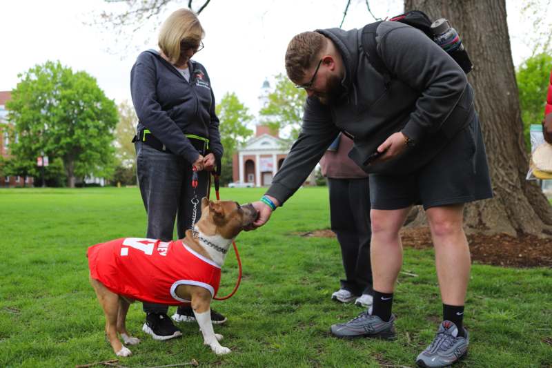 a man and woman petting a dog
