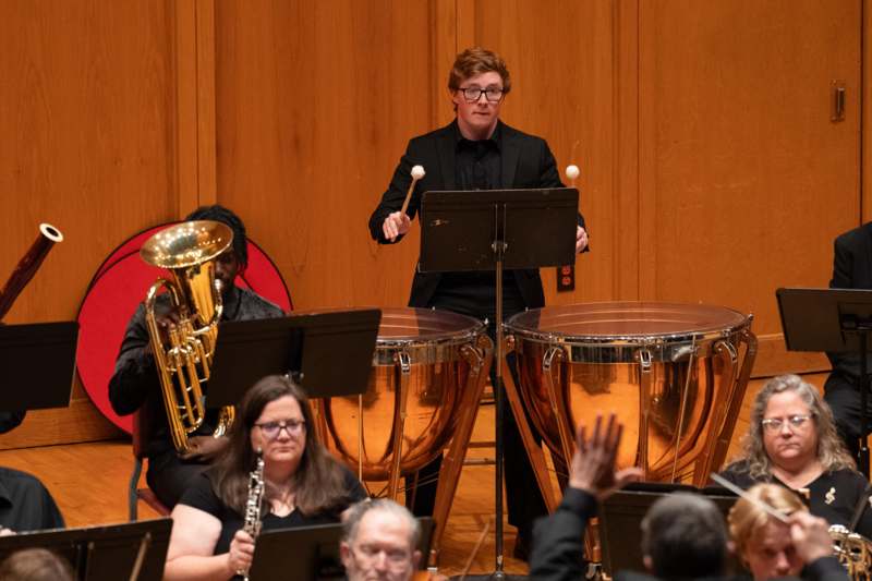 a person standing in front of a musical instrument