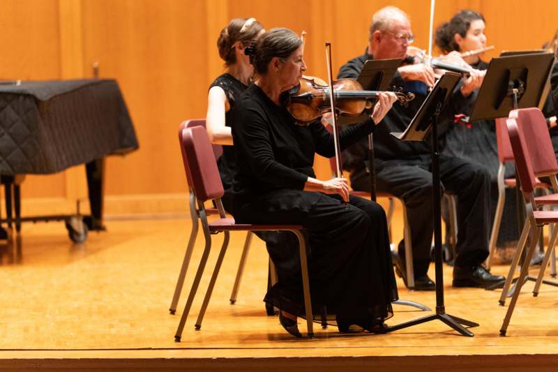 a group of people playing violin
