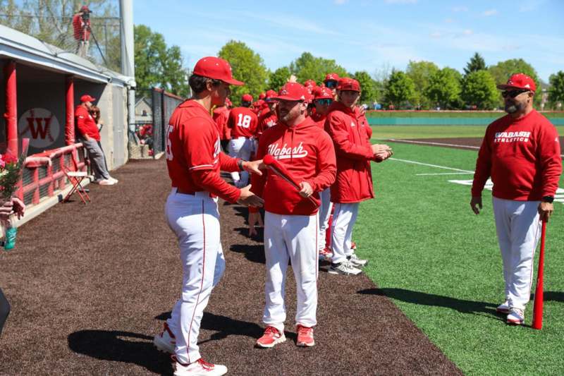a group of baseball players shaking hands on a field
