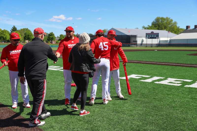 a group of people shaking hands on a field